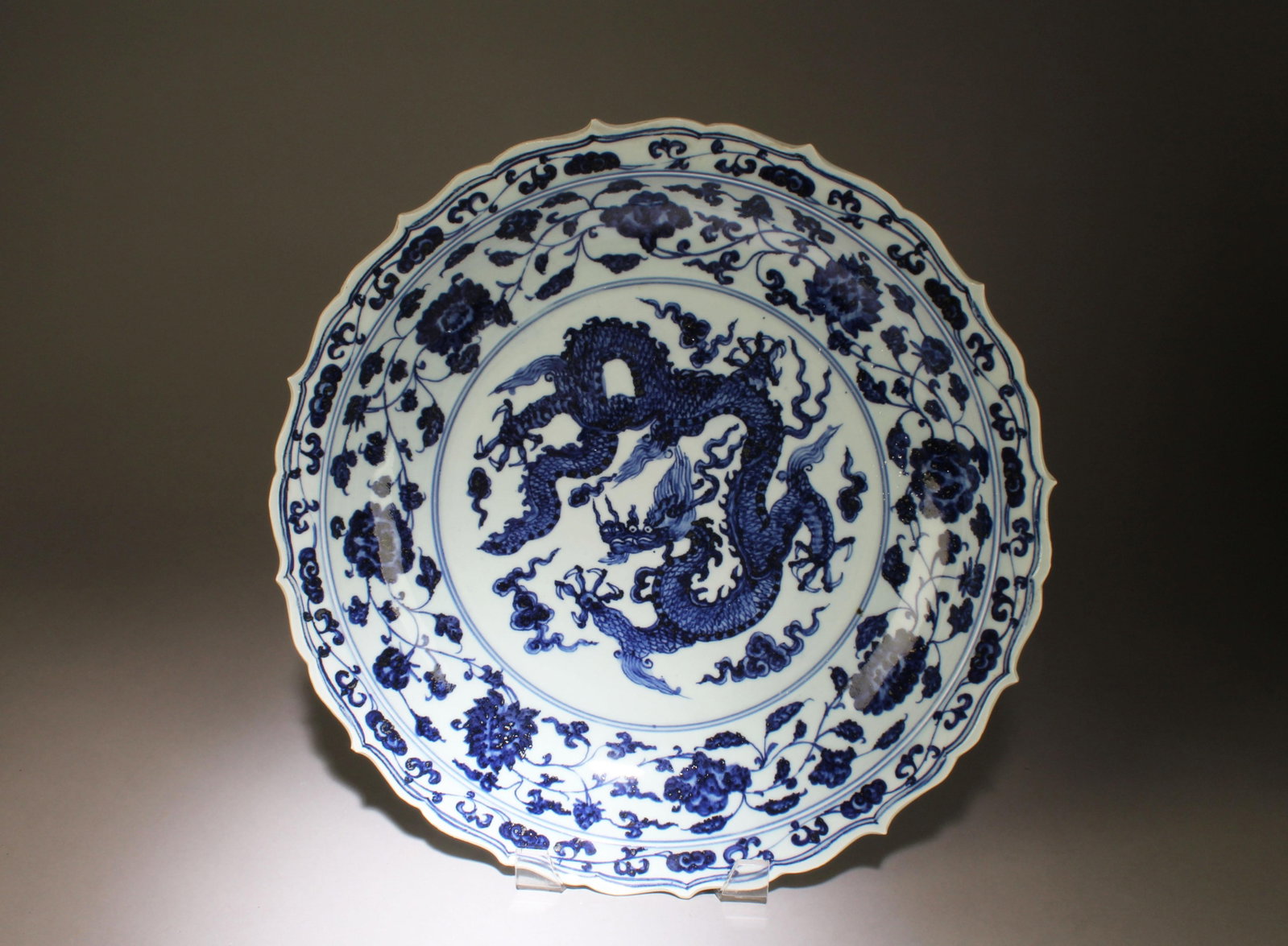 A Blue and White Porcelain Charger Plate: A Blue and White Porcelain Plate. 'Xuan De' mark on bottom. Diameter: 16.75''