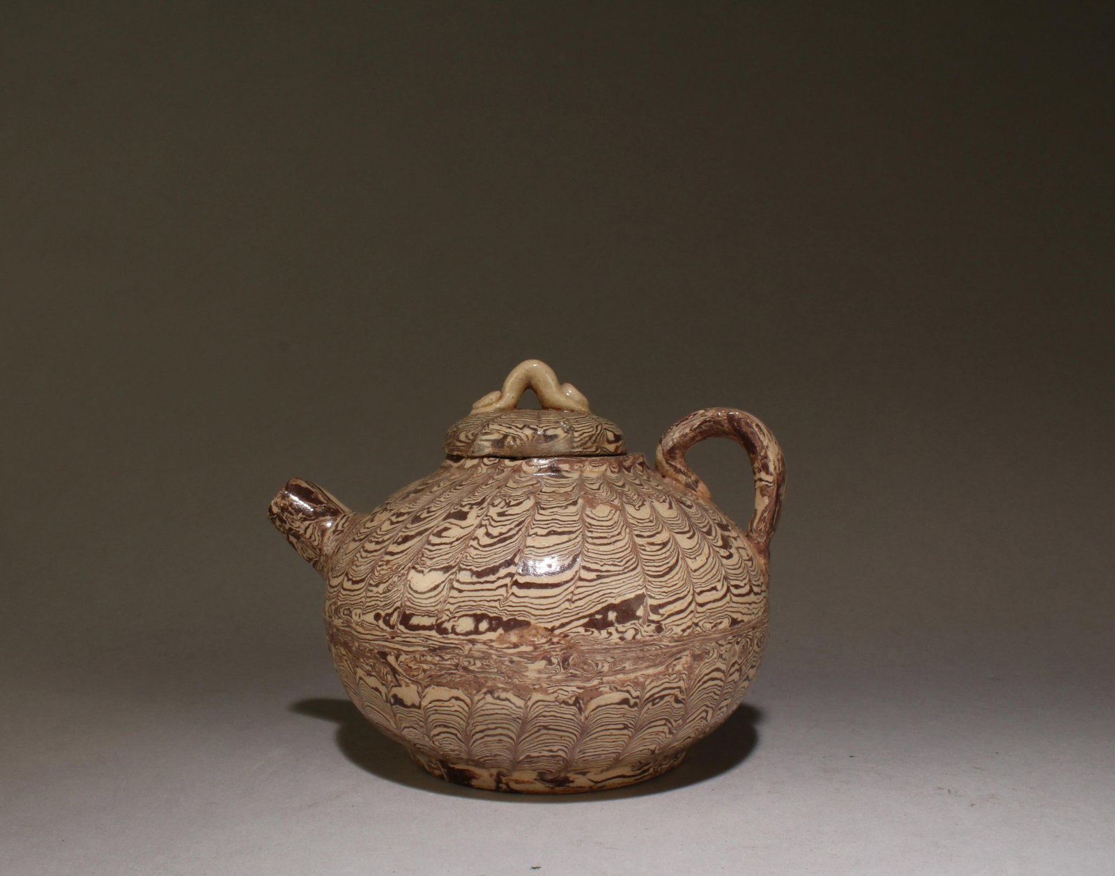 A Gray Glaze Black Stripe Twisted Porcelain Teapot: A Gray Glaze Black Stripe Twisted Porcelain Teapot. Dimensions: 3.75" x 4" x 4.75".