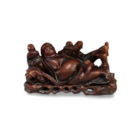 A Carved Wooden Buddha Figurine