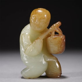 A CARVED JADE STANDING KID