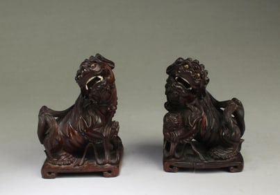 A Pair of Carved Wooden Mythical Beast Figurines