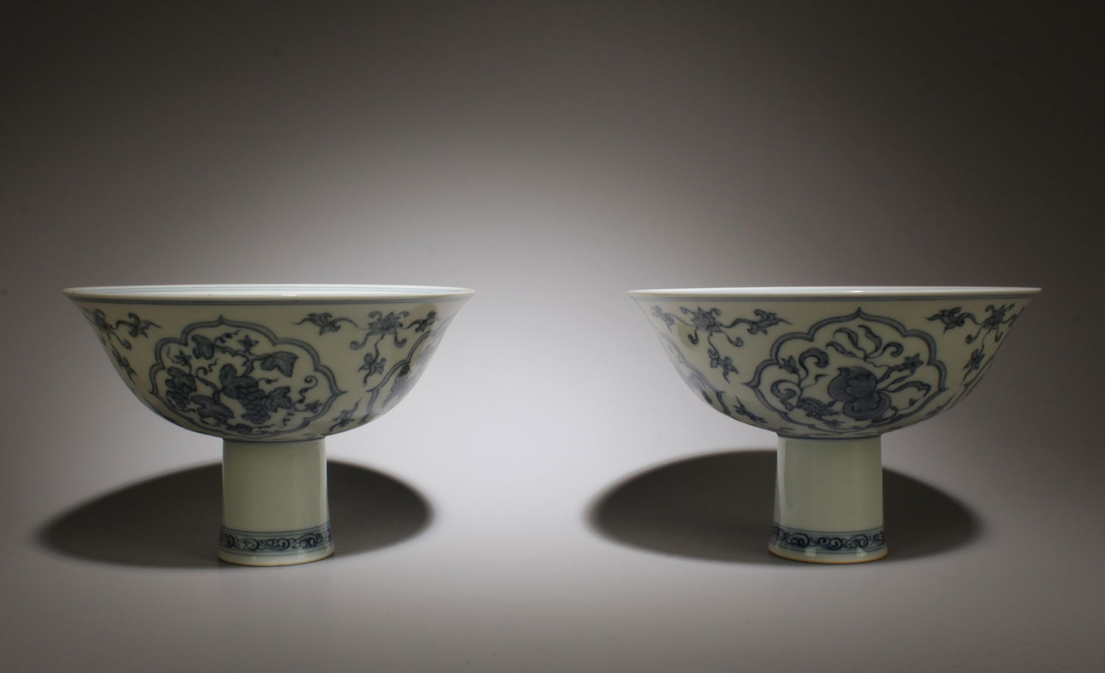 A Pair of Blue and White Stem Cups: A Pair of Blue and White Stem Cups. Dimension: 4" x 6.25".