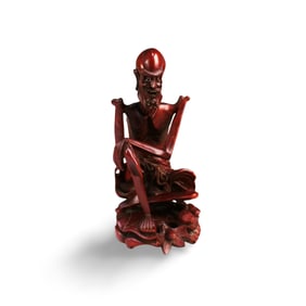 A Carved Wooden Monk Figurine