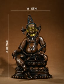 A Seated Yellow Wealth Deity Statue with Silver Inlay