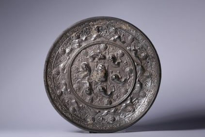 A Bronze Mirror with Sea Beast and Grape Motif