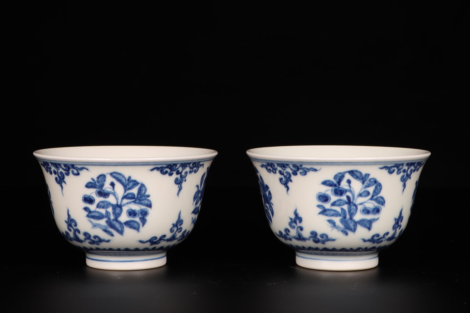 A Pair of Blue and White Cups: A Pair of Blue and White Cups. Dimensions: 3.25" x 2".