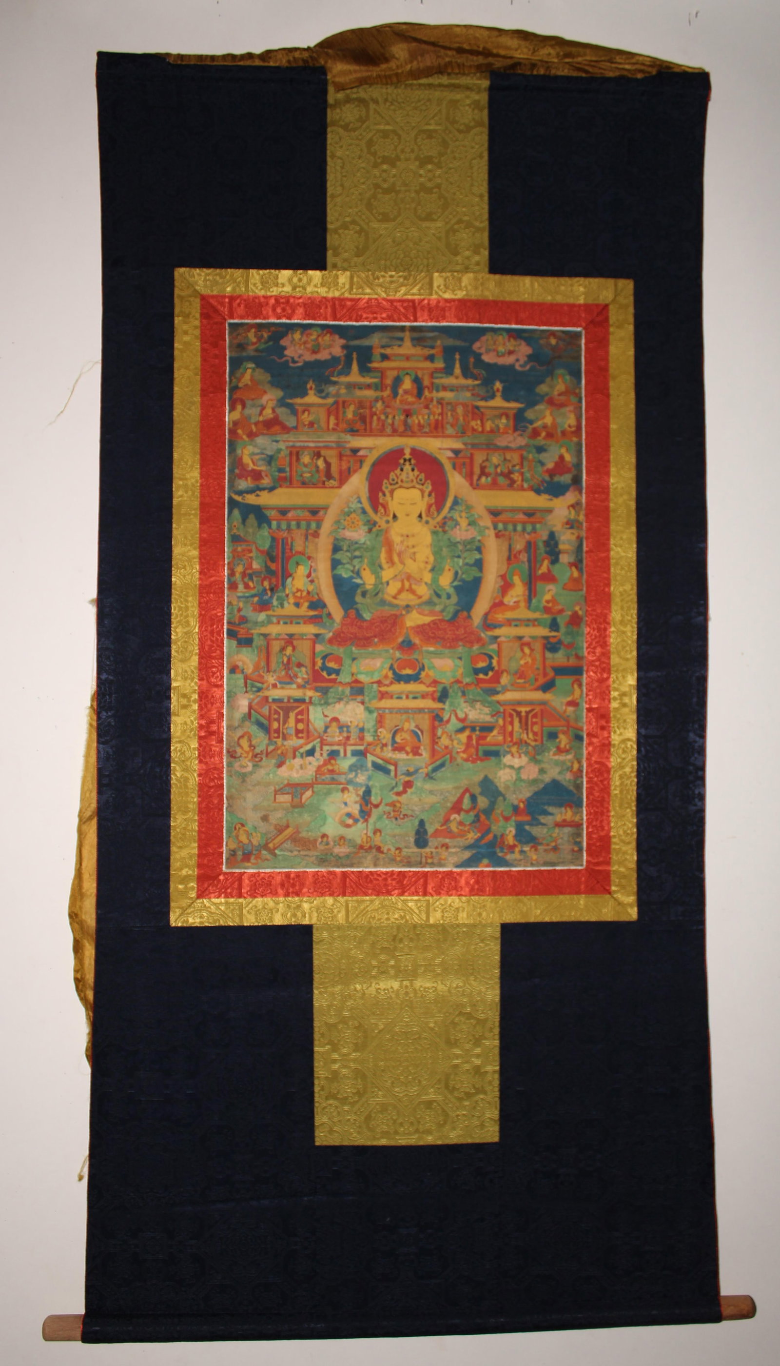 A Tibetan Thangka: A Tibetan Thangka. Outer Dimension: 48" x 23", Inner Dimension: 21" x 16".