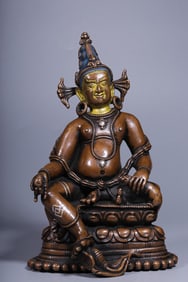 A Brass Yellow Jambhala Statue with Silver Inlay