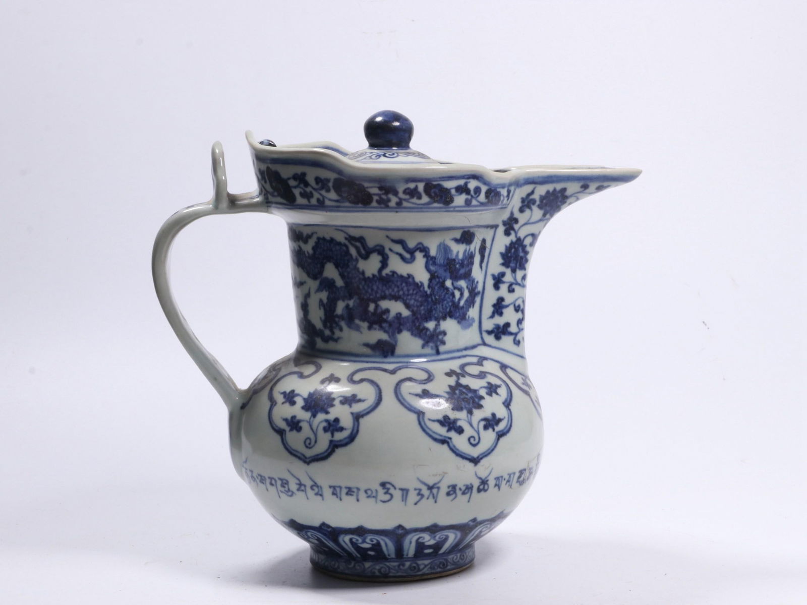 A Blue and White Monk Cap Teapot with Dragon Motif: A Blue and White Monk Cap Teapot with Dragon Motif . Height: 9.84in; Width: 8.27in.