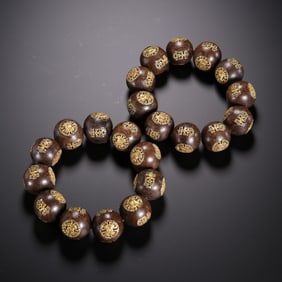 A Pair of Agarwood Prayer Beads Inlaid with Gilt Silver