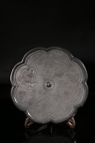 A Bronze Mirror With Floral Scroll Design