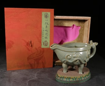 A Celadon Glazed Tripod Cup With Chi Dragon Motif
