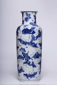 A Blue And White Vase With Butterfly Motif
