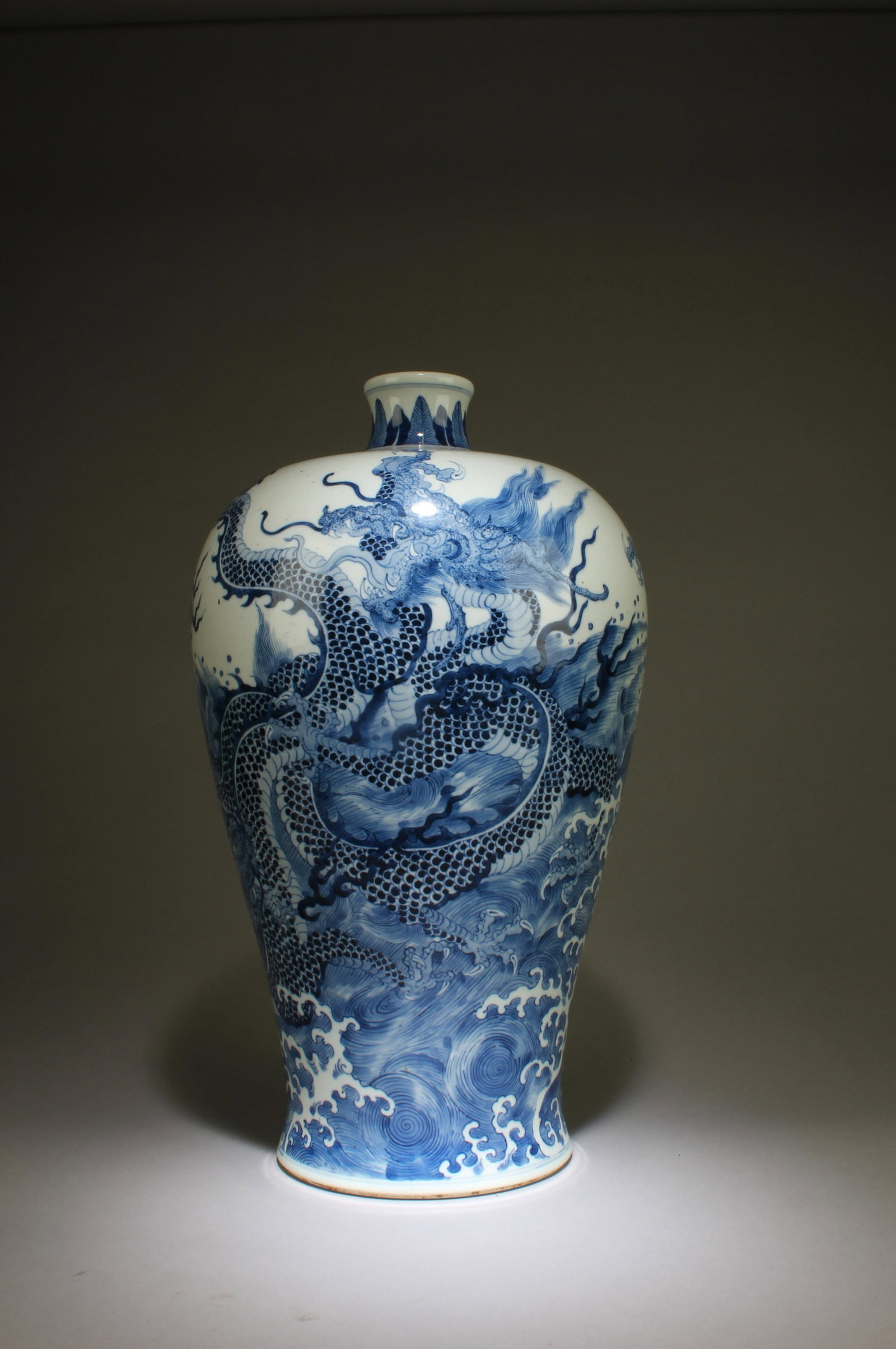 A Blue and White Vase with Dragon Motif: A Blue and White Vase with Dragon Motif. "QianLong" mark at base. Dimensions: 17.5in x 10in.