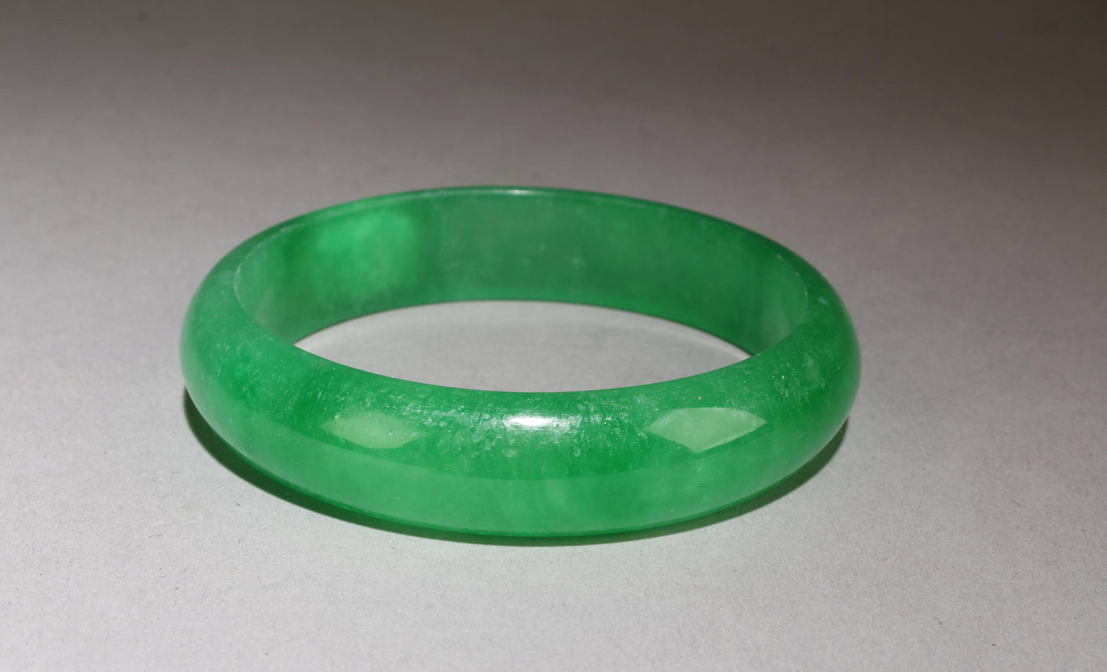 A Jade Bangle: Jade Bangle. Outer Diameter: 2.75", Inner Diameter: 2.25".