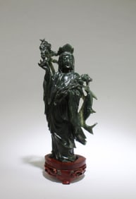 A Carved Spinach Jade Guanyin Statue