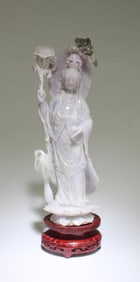 A Carved Lavender Color Jade Guanyin Statue