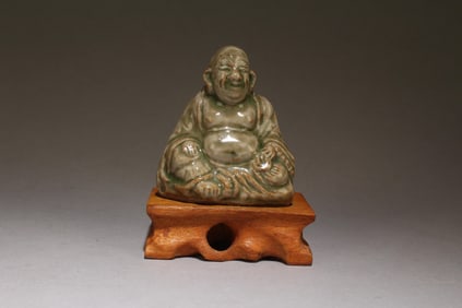 A Celedon Glazed Buddha on Wooden Stand