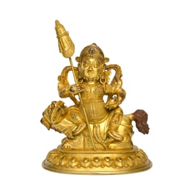 A Sino-Tibetan Gilt Bronze Figure of Jambhala