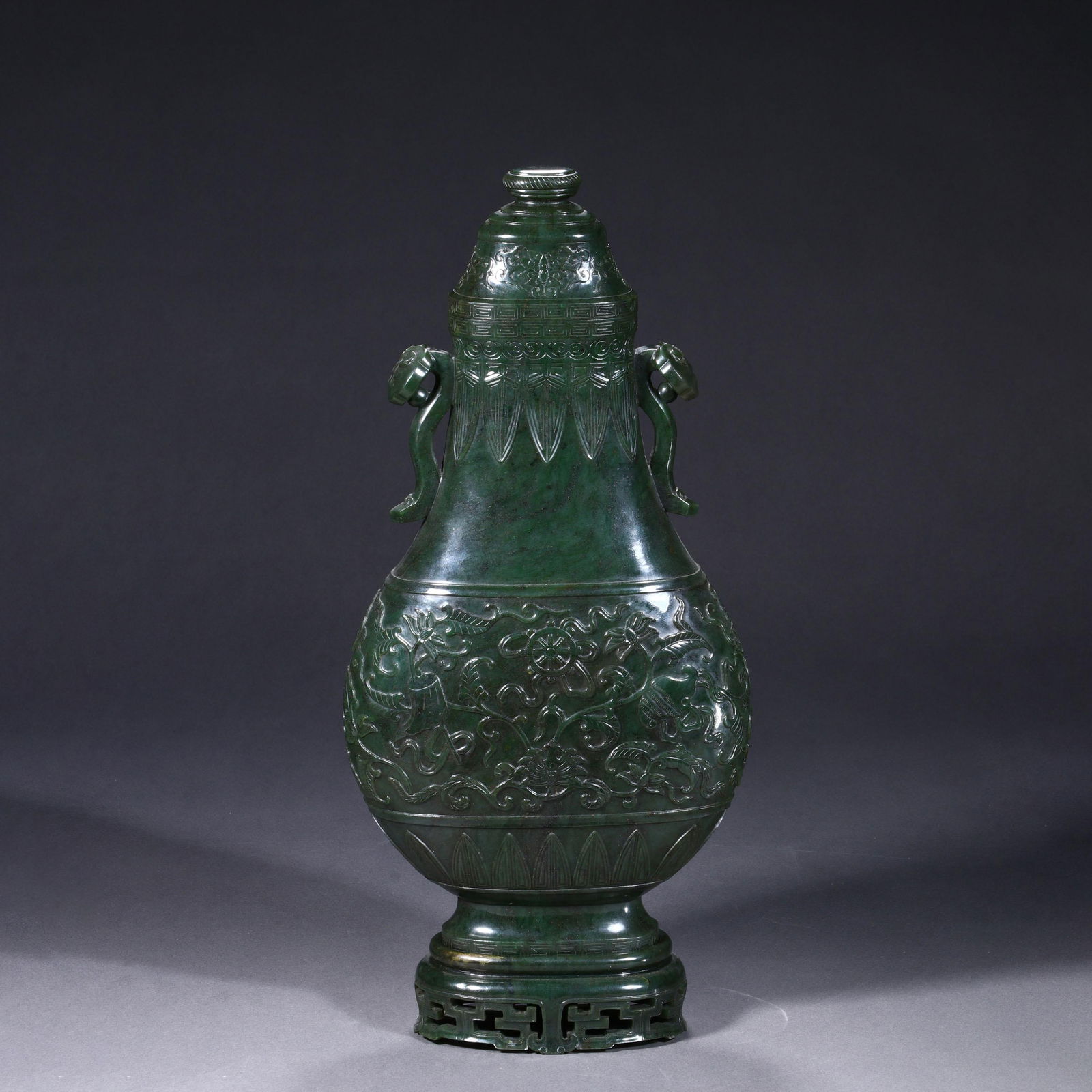 Carved green jade double-eared bottle: Carved green jade double-eared bottle. Height: 14.96" Width: 7.09"