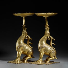 Pair of Gilt Bronze Mythical Beast Candlesticks