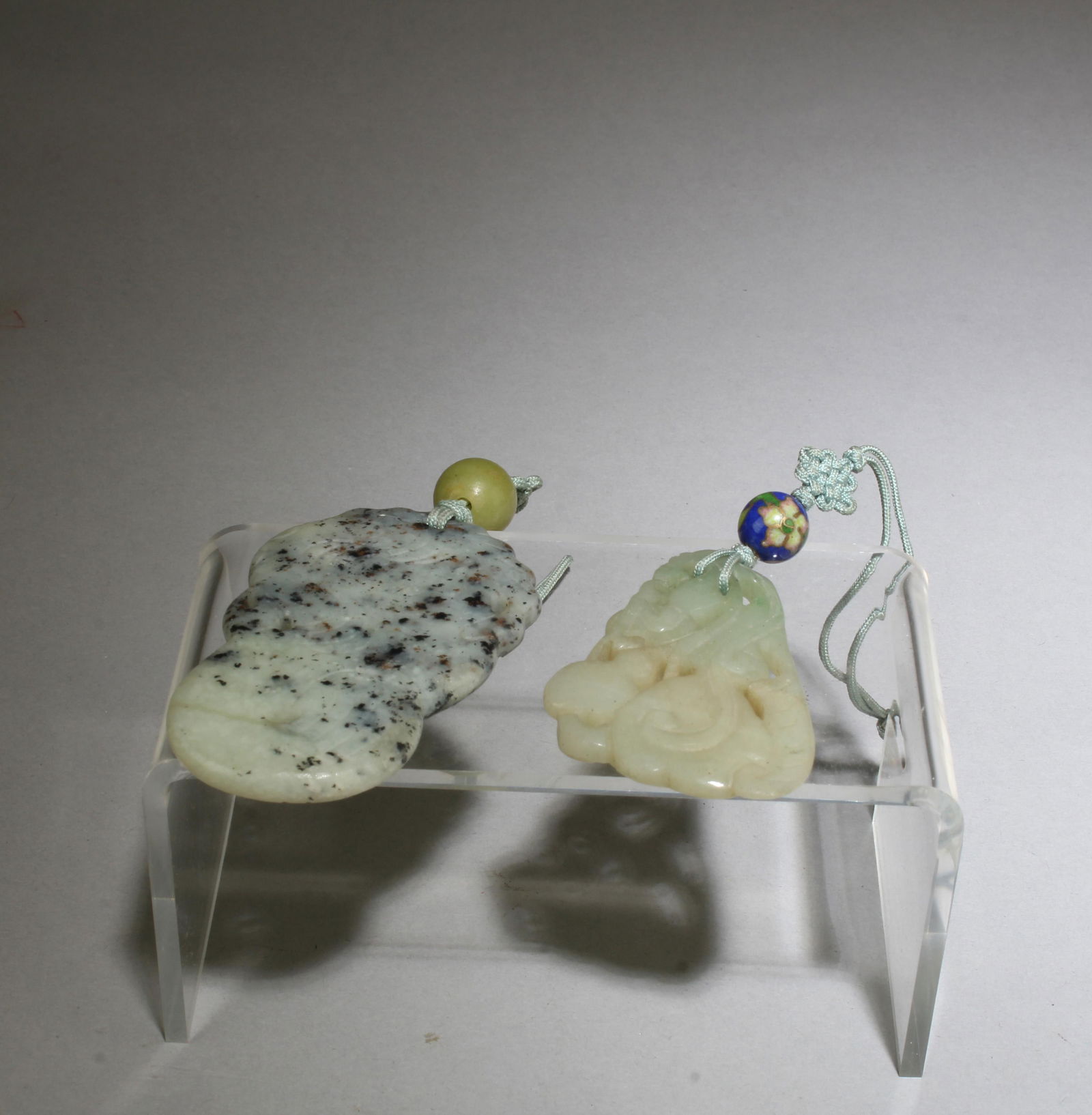 A Group of Two Jade Pendants: A Group of Two Jade Pendants. Height: 2.25"