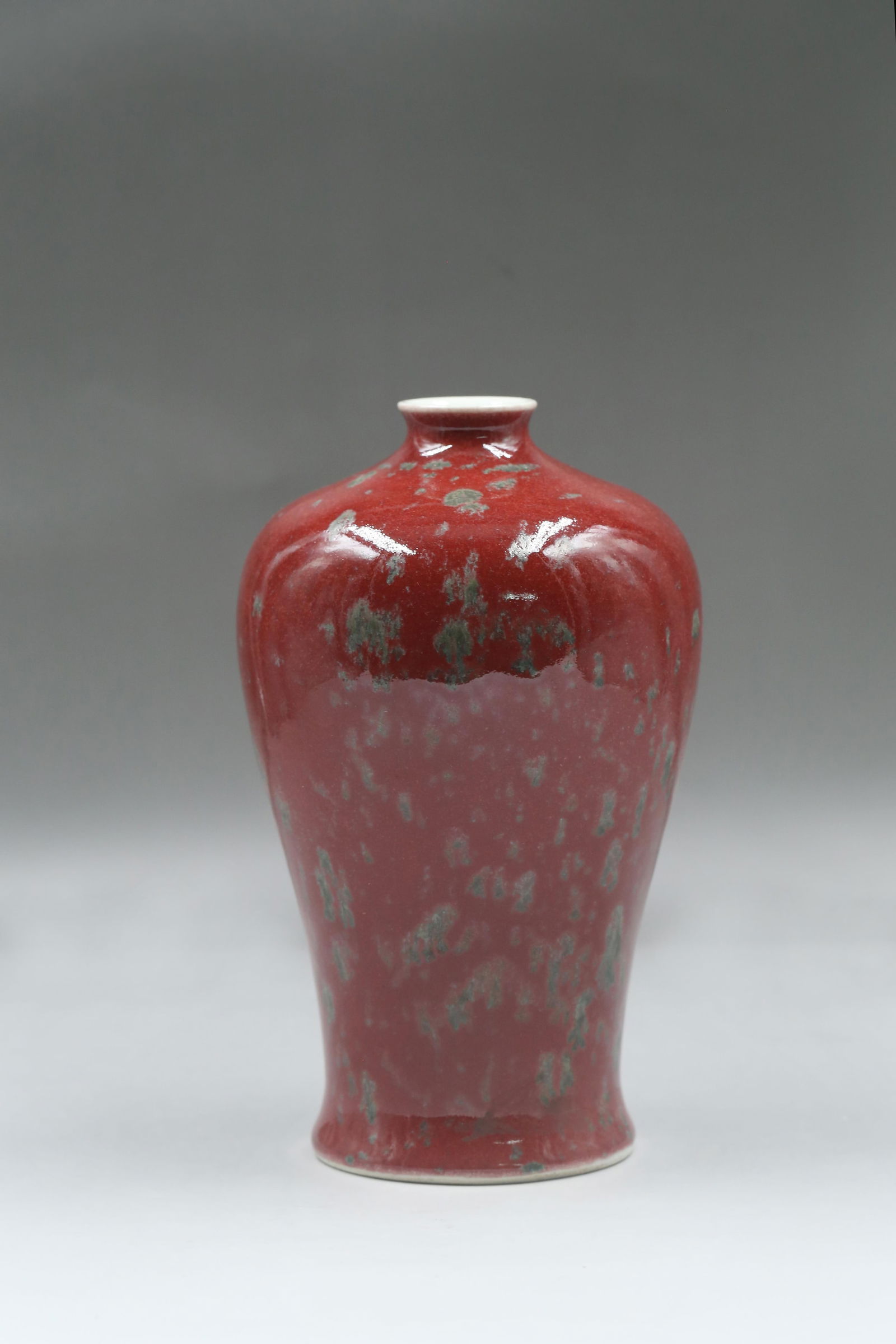 A Red-Glazed Porcelain Vase: A Red-Glazed Porcelain Vase. 'KangXi' mark at base. Height: 8.20"