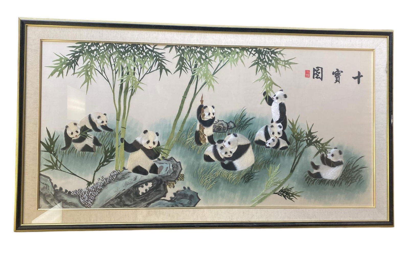 A Framed Embroidery Painting: A Framed Embroidery Painting Depicting Pandas and Bamboo. Dimensions: 34" x 62.5".