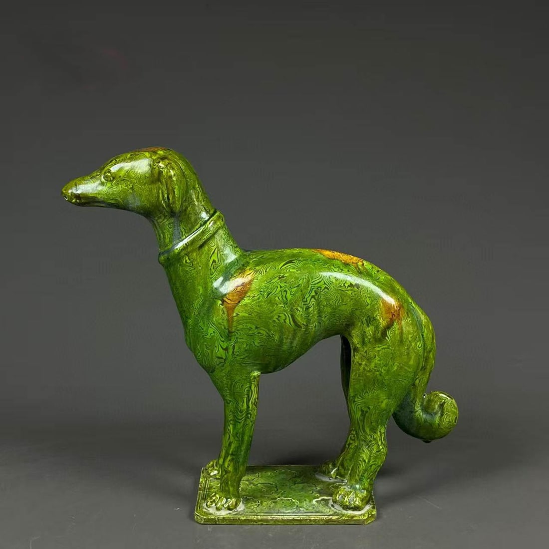 A Green-Glazed Dog Figure: A Green-Glazed Dog Figure. Height: 9.25", Length: 10.25"