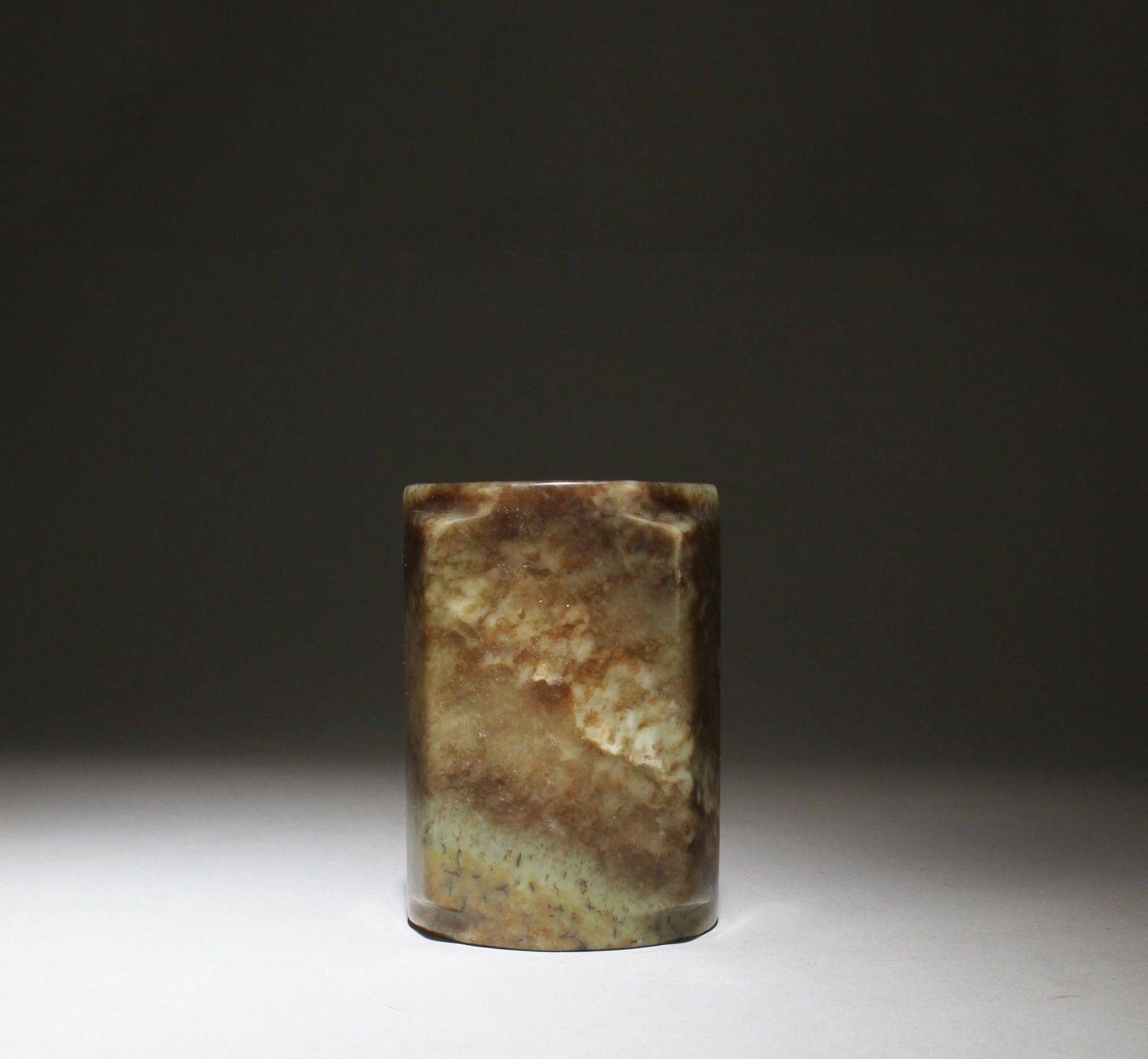 A Carved Jade 'Cong': A Carved Jade 'Cong'. Height: 3.74in. Diameter: 2.76in.