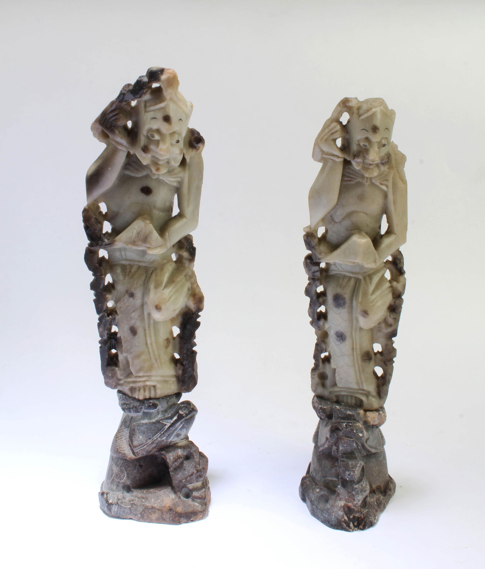 A Pair of Carved Stone Figurines: A Pair of Carved Stone Figurines with stand. Height: 7.75" (with stand)