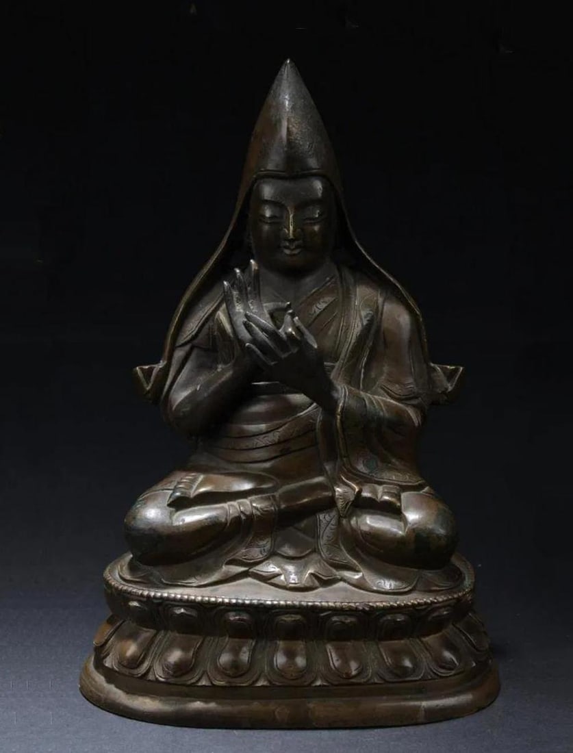 Antique Chinese Bronze Buddha Statue: Antique Chinese bronze Buddha statue, carved male figure, seated cross legged with hands in Mudra position, wearing robes and a loose pointed cape, on double lotus blossom base. Length: 4" Height: 6"
