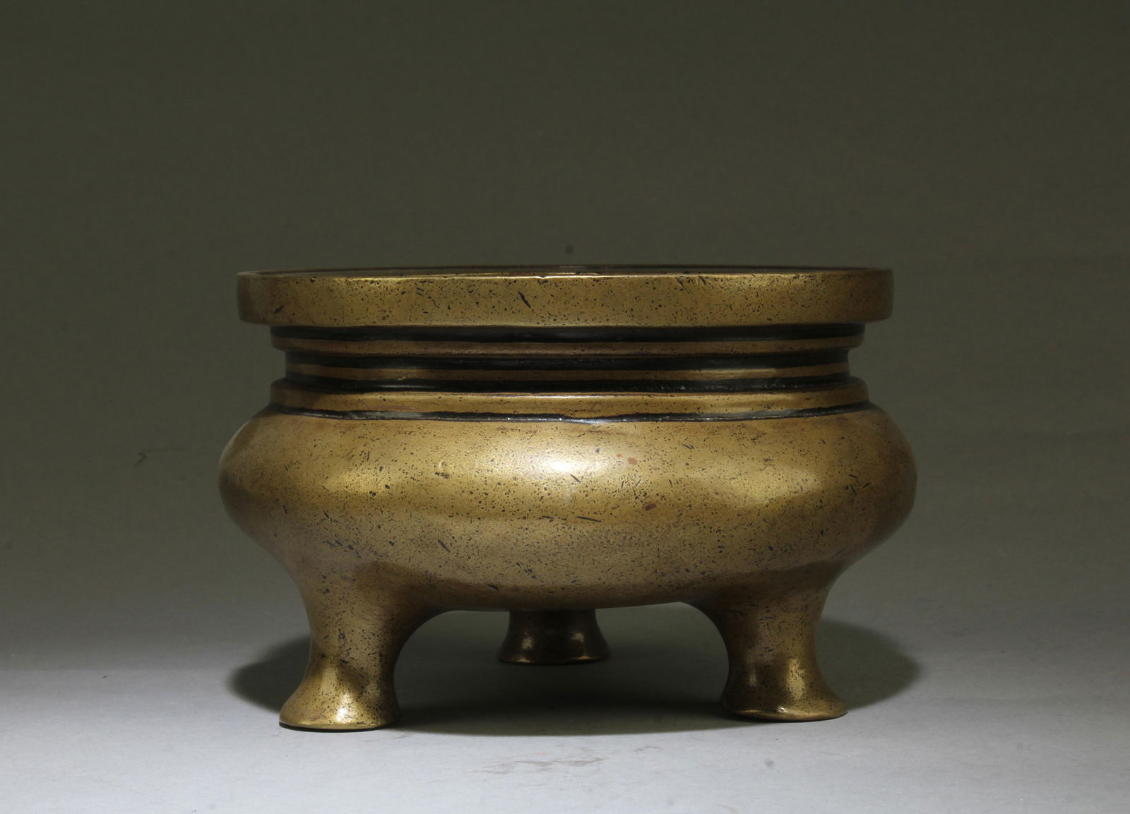 Chinese Bronze Tripod Censer: Chinese Bronze Tripod Censer. A four character mark is imprinted at the bottom. Diameter: 5.75"
