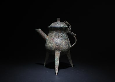 A Chinese Bronze Three-Legged Wine Pot