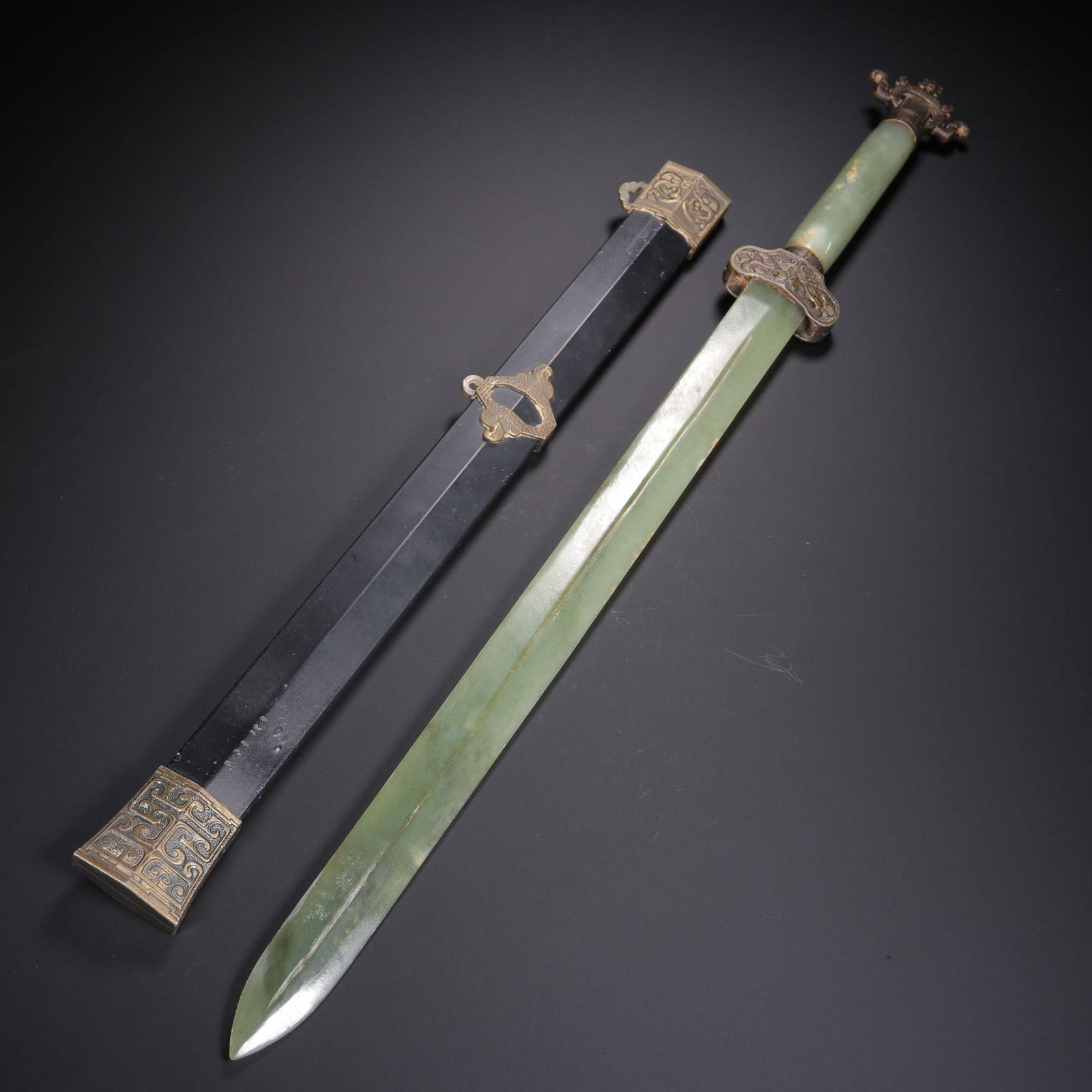 A Hetian Jade Sword: A Hetian Jade Sword. Dimensions: 19.69in x 1.81in; Weight: 0.758lb.