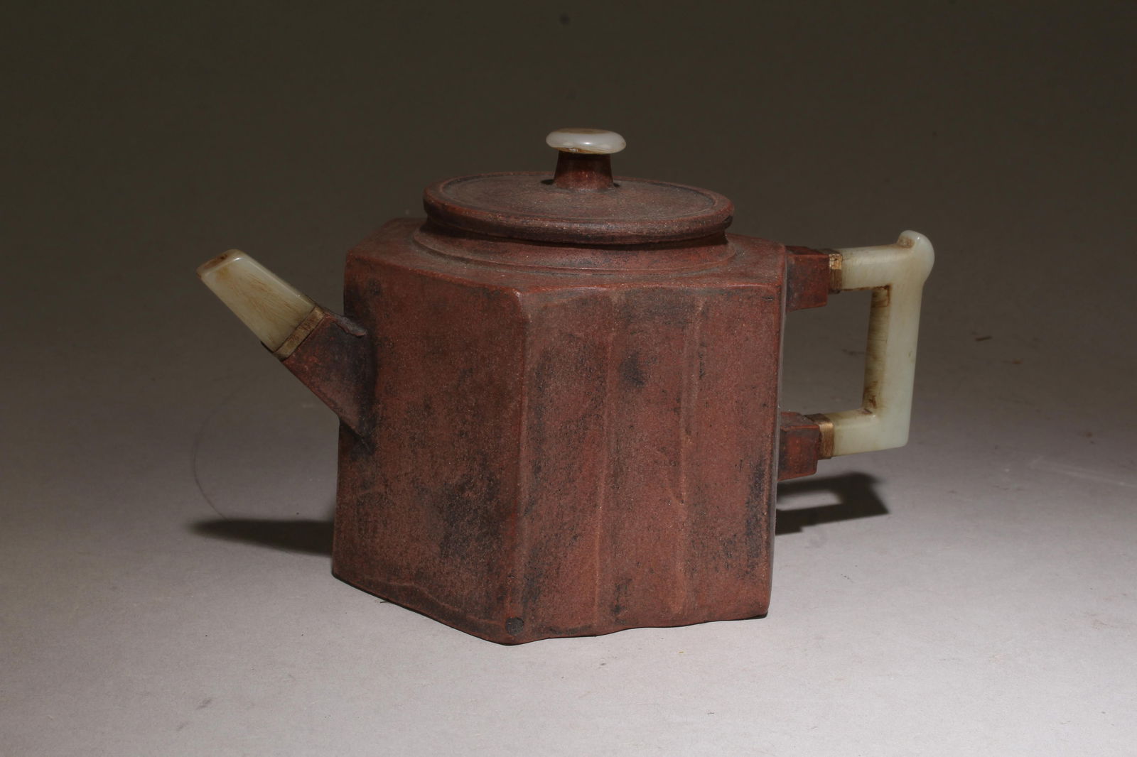 A Zisha Teapot with Jade Accents: A Zisha Teapot with Jade Accents. Dimensions: 4.25" x 6.5".