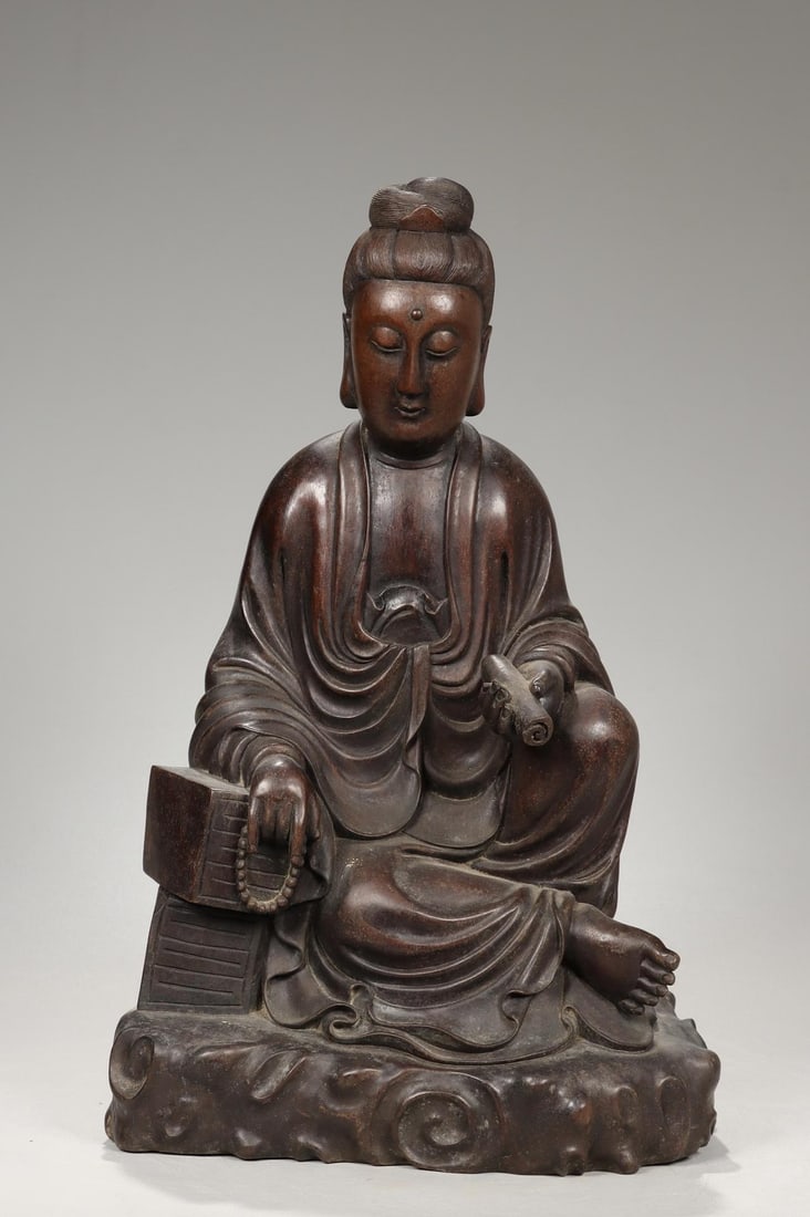 A Sourwood Carved Guanyin Ornament: A Sourwood Carved Guanyin Ornament. Dimensions: 14.17in x 8.66in x 5.91in; Weight: 8.82lbs.