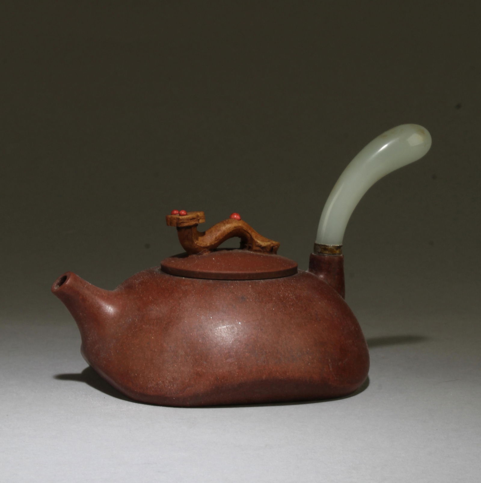 A Zisha Teapot: A Zisha Teapot, with a jadestone handle. Length: 6" Height: 3.75"