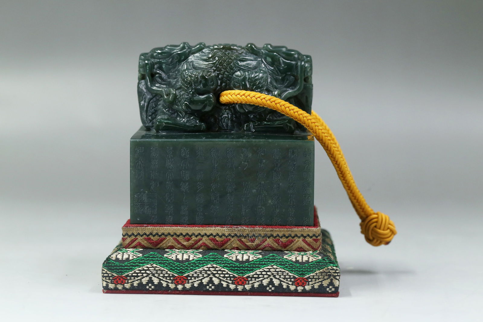 A Carved Jade Imperial Seal: A Jade Imperial Seal, with a carved mythical beast finial top. Comes fitted with a base. Height: 3.46in. Length: 3.15in.