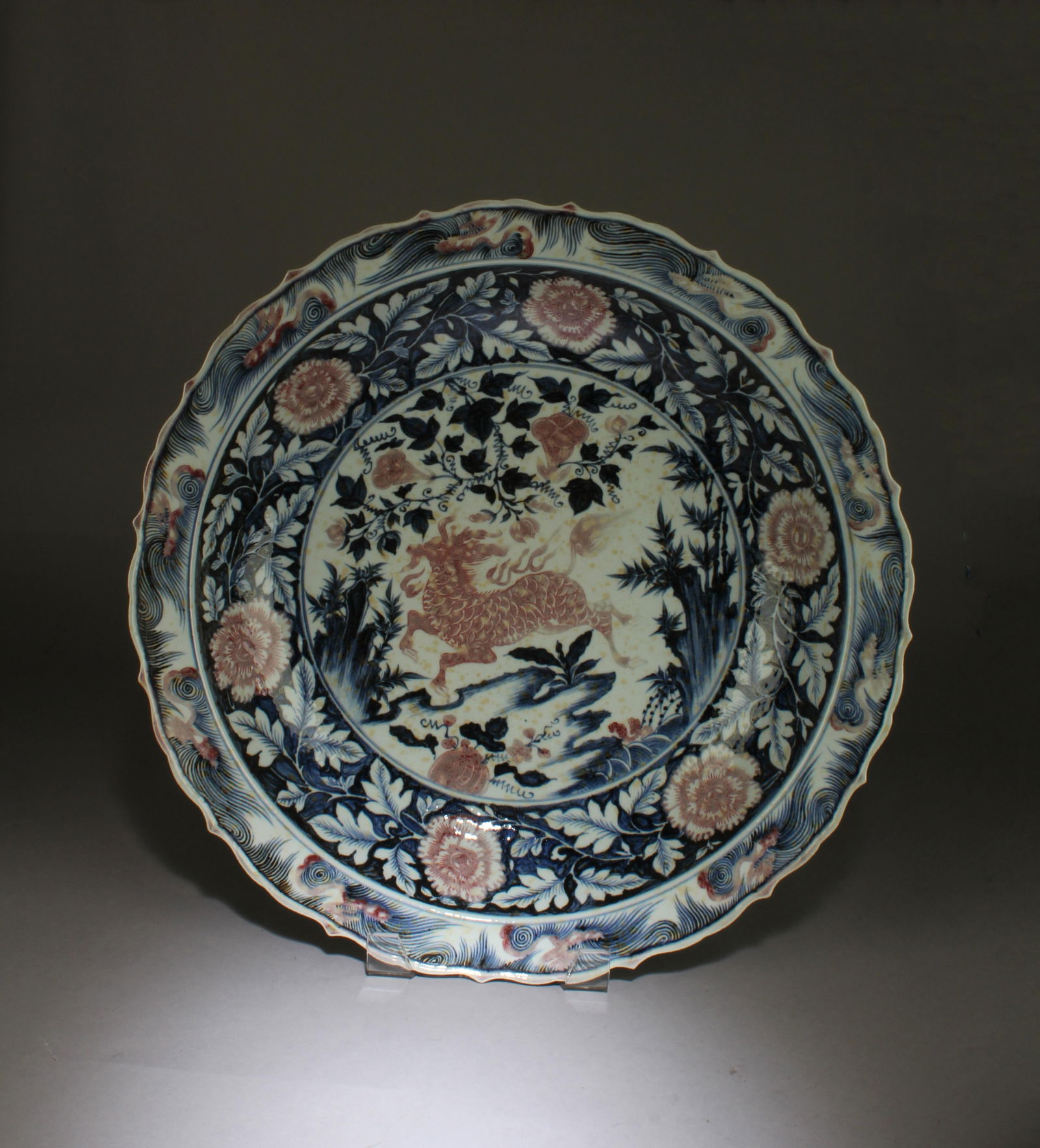 An Iron Red Blue & White Charger: An Iron Red Blue & White Charger. Diameter: 18"