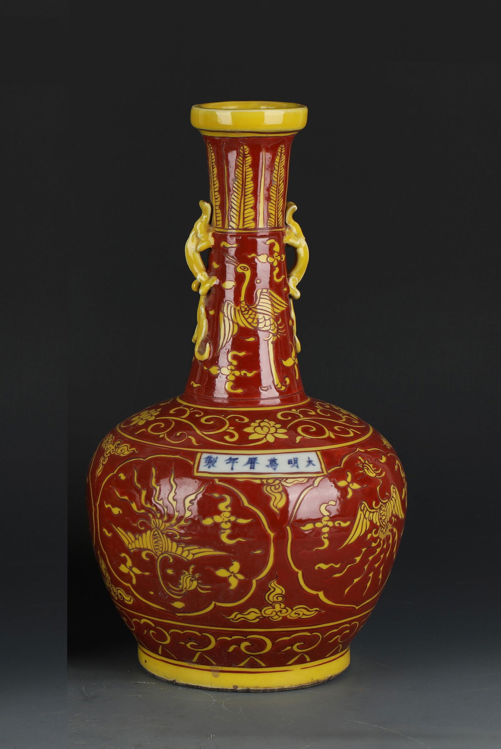 Phoenix Double-Eared Porcelain Vase: A Porcelain Vase in red and yellow, depicting phoenixes. 'WanLi' mark on body. Height: 13.4"