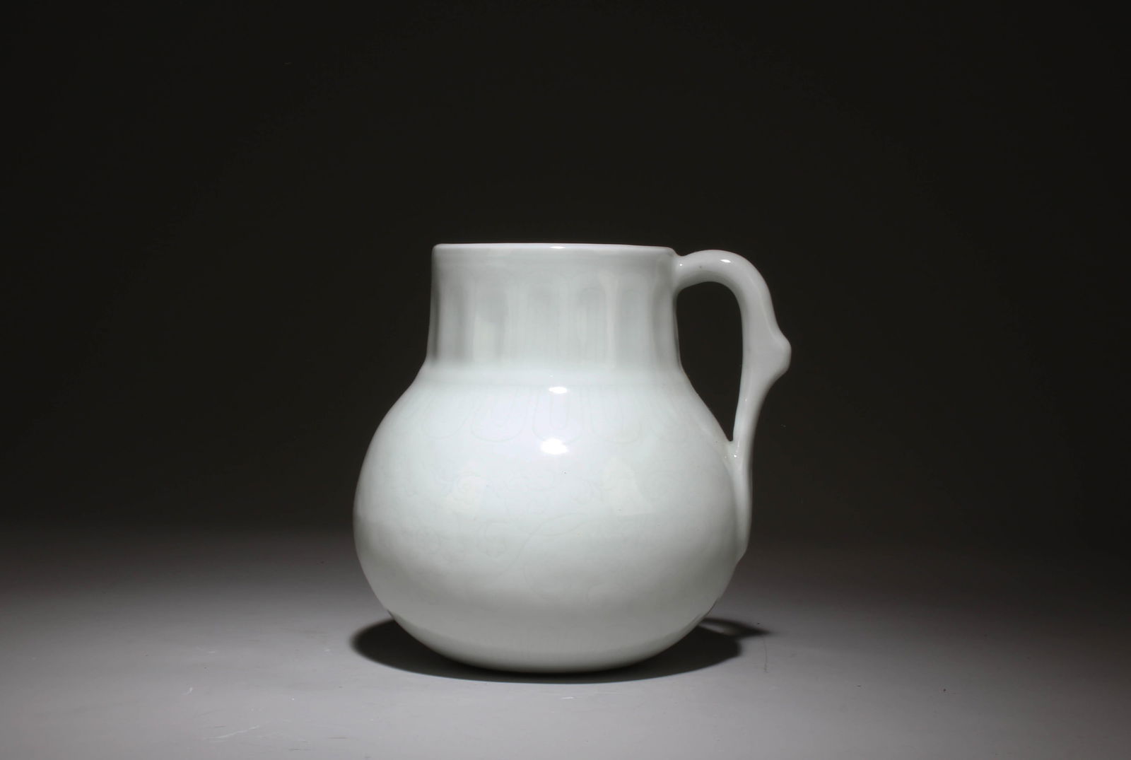 A Porcelain Pot with Handle: A Porcelain Pot with Handle. Dimensions: 5" x 5.25".