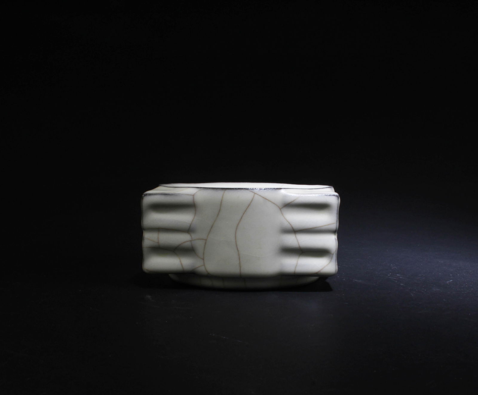 A Glazed Porcelain Ink Washer: A Glazed Porcelain Ink Washer. Height: 2.5" Length: 4.6"