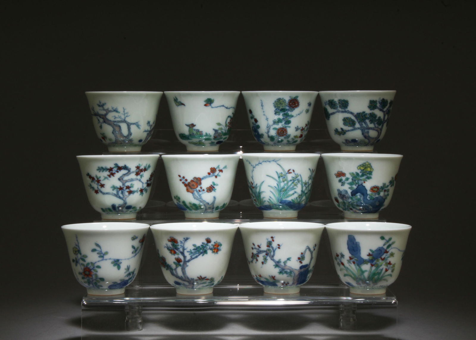 A Set of Twelve Doucai Glazed Cups with Box: A Set of Twelve Doucai Glazed Cups with Box. Box Dimensions: 16.75" x 10" x 5.5". Cup Dimensions: 2" x 2.6".