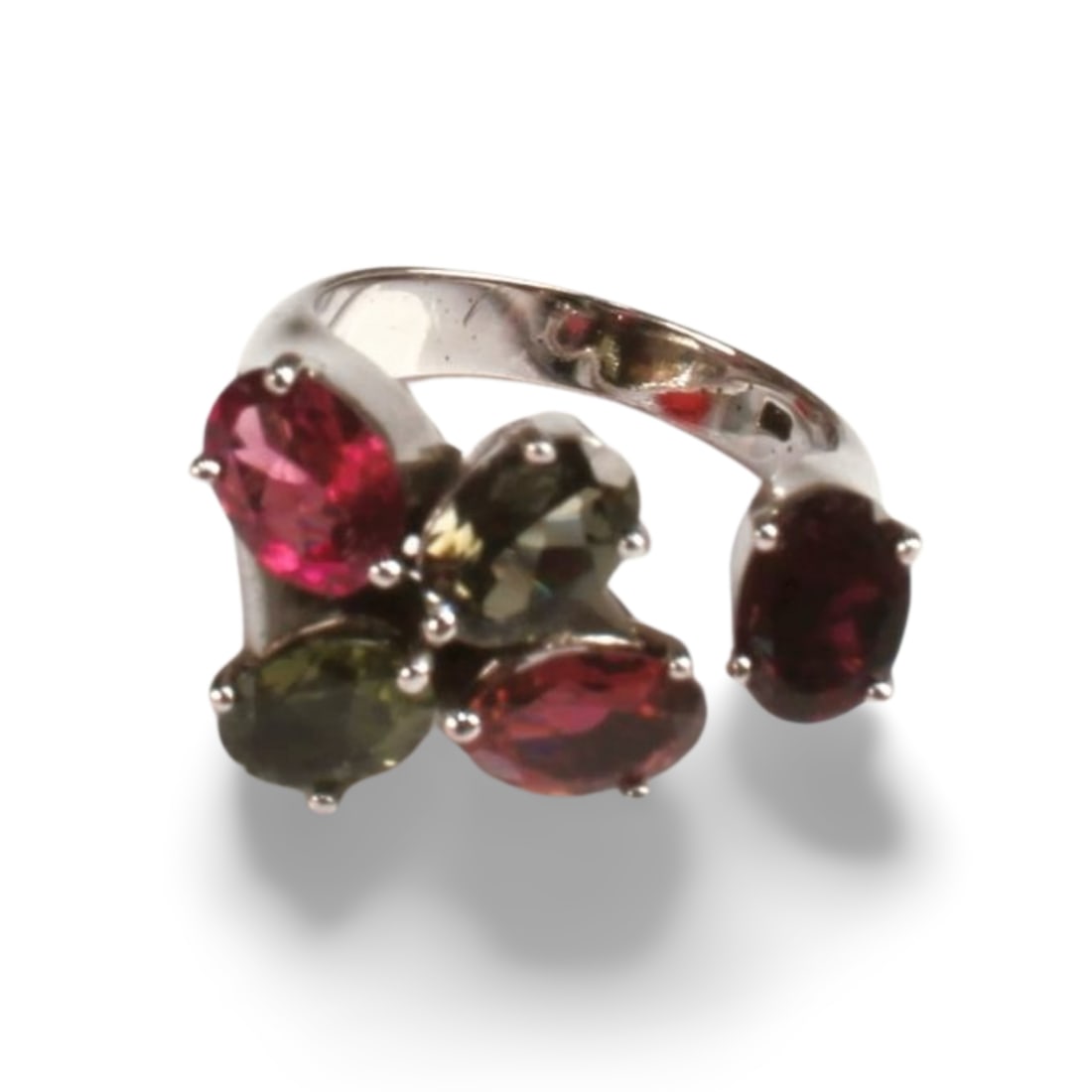 China Tourmaline Ring: A ring with square tourmaline stone, placed in clawed setting with thick silver band. Inner diameter 0.6 ".