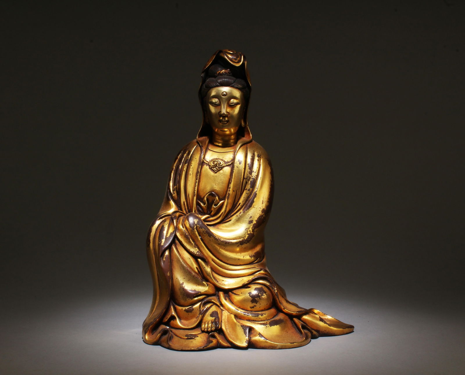 A Stitting Gilt Bronze Guanyin Statue: A Stitting Gilt Bronze Guanyin Statue. Dimensions: 11.3" x 8.5".