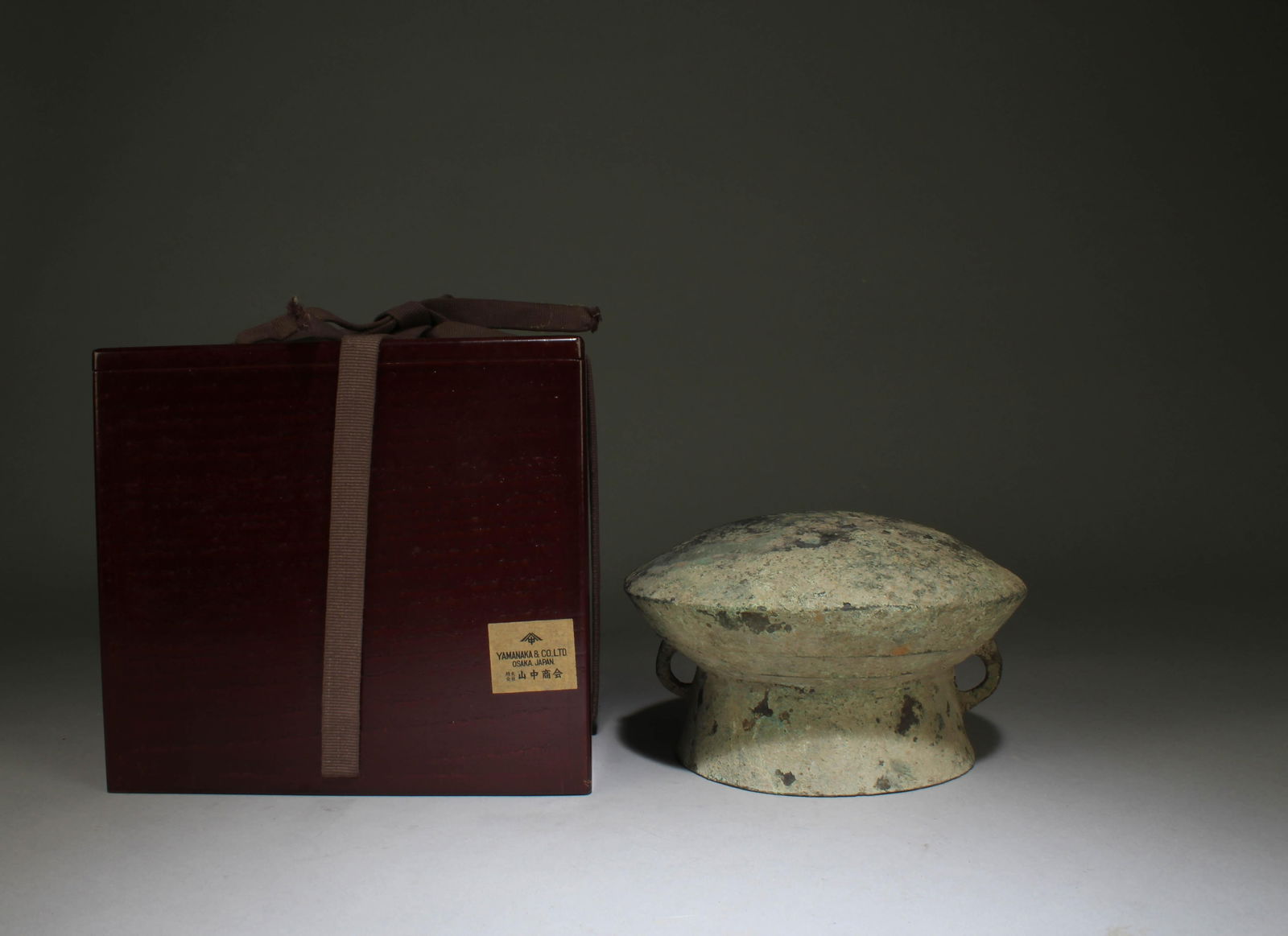 A Chinese Bronze Drum: A Chinese Bronze Drum. Dimensions: 6.5" x 3.5"