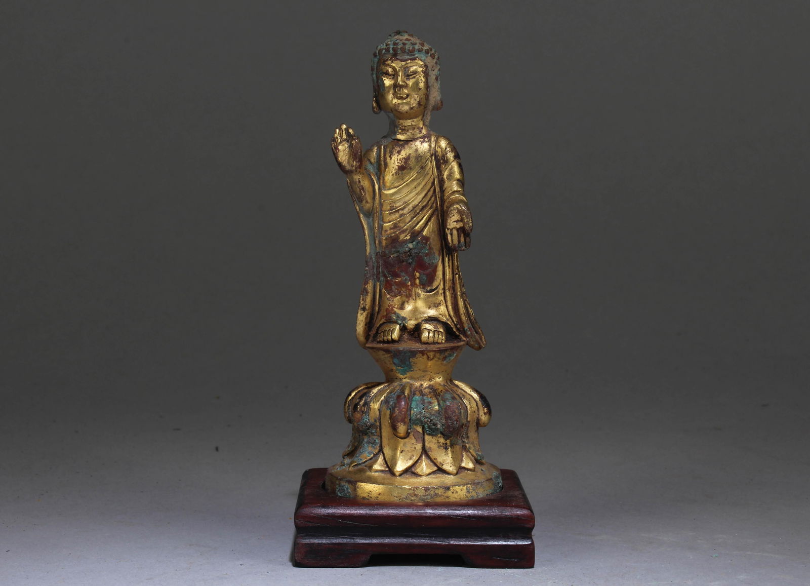 A Chinese Gilt Bronze Buddha: A Chinese Gilt Bronze Buddha. Dimension: 5" x 1.8" x 1.8". Dimension with Stand: 5.5" x 2.4" x 2.4".