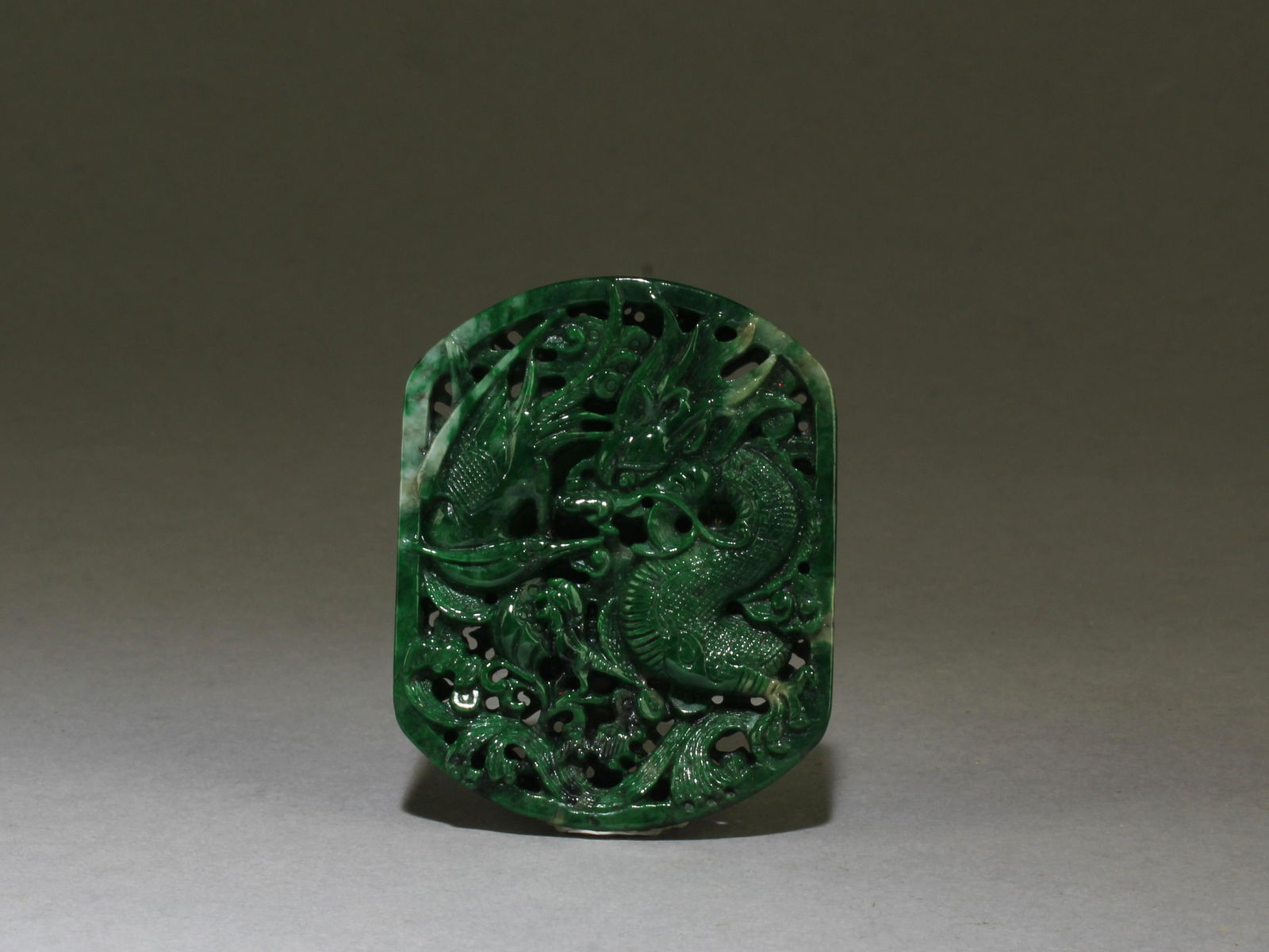 A Jadeite Jade Openwork Pendant: A Spinach Jade Openwork Pendant. Guaranteed natural color. Height: 2"