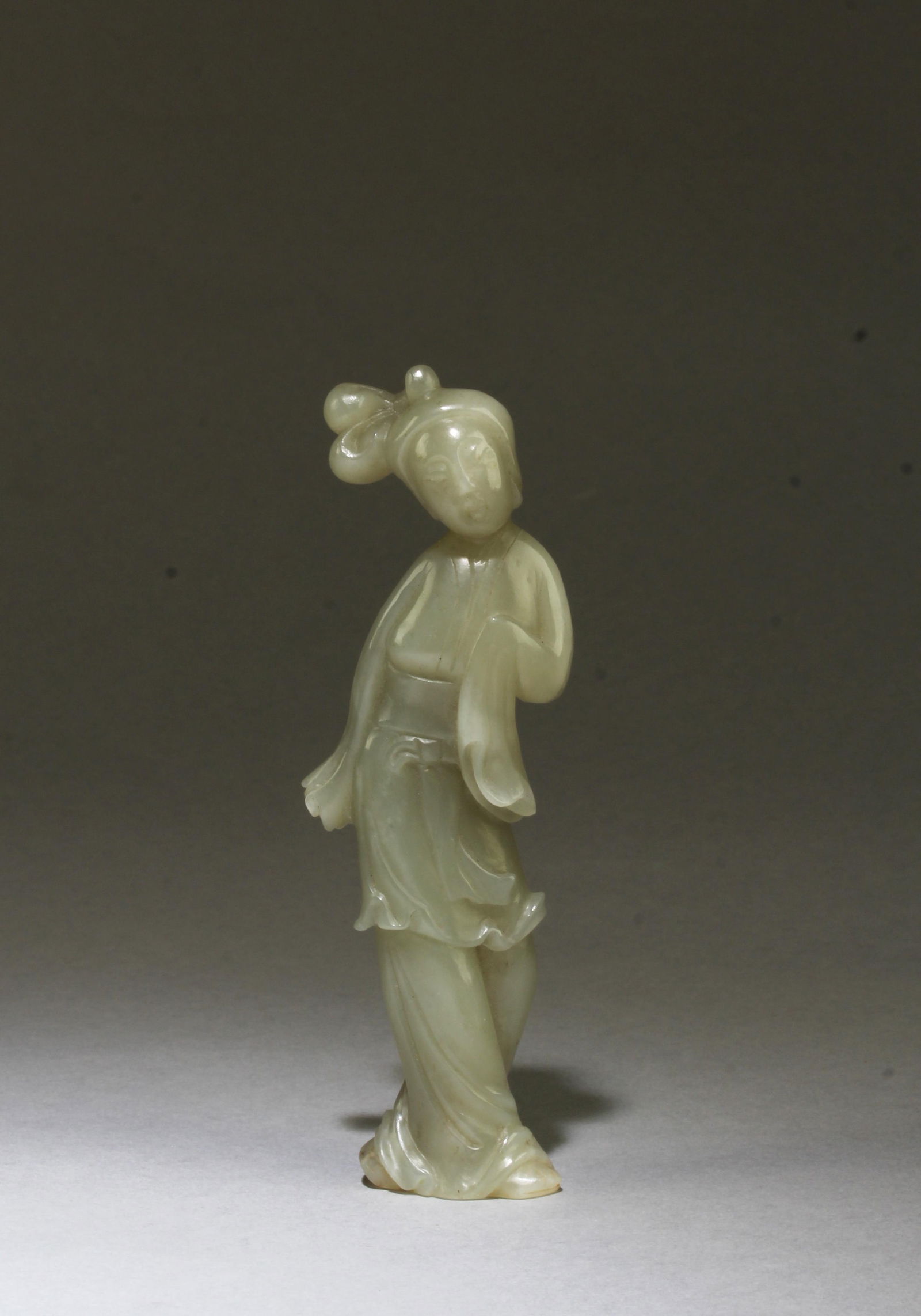 Chinese Jade Ornament: Intricately carved Jade ornament, depicting a maiden wearing long flowing robe with head slightly tilted. Height: 5"